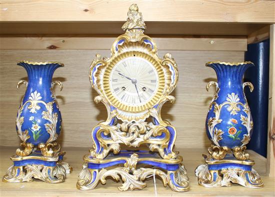 A 19th century French Ed Honore of Paris porcelain three piece clock garniture, clock 34cm, vases 23cm